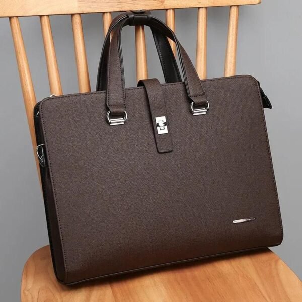 A brown leather laptop briefcase sitting on a wooden chair, showcasing its sleek design and silver accents.