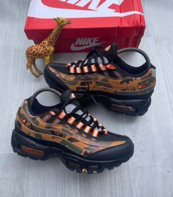 A pair of Nike Air Max camouflage sneakers with orange accents, showcasing Modern Luxury and Urban Edge style.