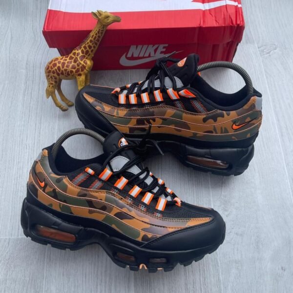 A pair of Nike Air Max camouflage sneakers with orange accents, showcasing Modern Luxury and Urban Edge style.