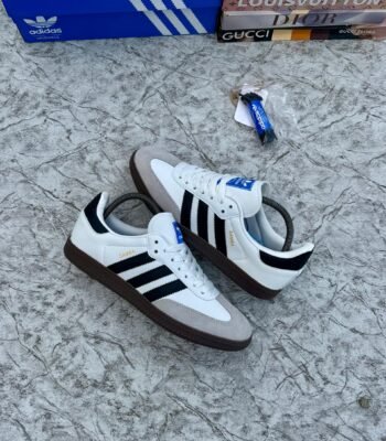 Luxury Adidas Samba sneakers in white, black, and brown, showcasing sleek design and premium materials.