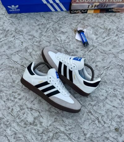 Luxury Adidas Samba sneakers in white, black, and brown, showcasing sleek design and premium materials.