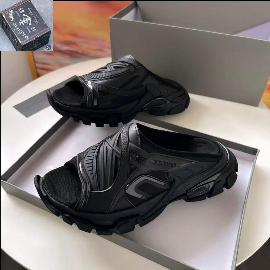 root A pair of black Balenciaga rubber mules in a shoe box, showcasing the modern design and luxury quality of the shoes.
