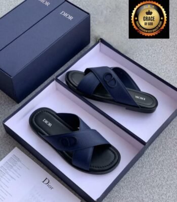 A pair of navy blue Dior slide sandals in a box, showcasing Modern Luxury and Urban Edge style.