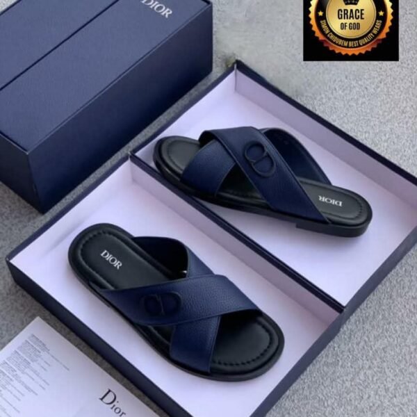 A pair of navy blue Dior slide sandals in a box, showcasing Modern Luxury and Urban Edge style.