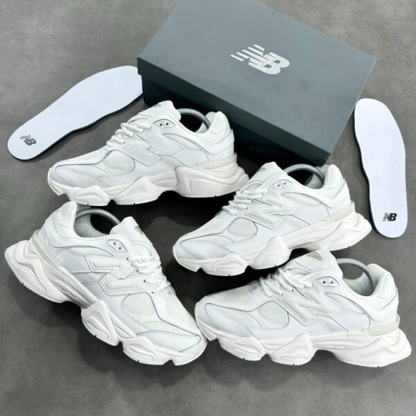 A stunning visual showcasing the New Balance 574S Triple White Sneakers, elegantly arranged with their box and insoles, highlighting the exceptional craftsmanship and attention to detail.