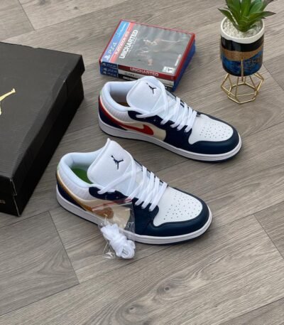 A pair of white, navy, and gold Air Jordan 1 Mid sneakers on a wooden floor, exuding Modern Luxury and Urban Edge style.