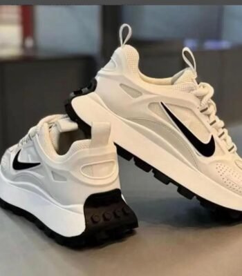 A pair of white Nike running shoes with black accents, showcasing sleek design and superior comfort for the urban man in Nigeria.