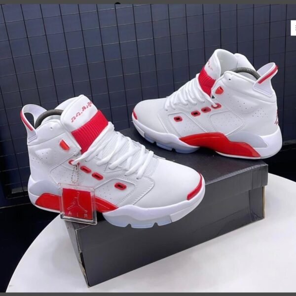 A pair of white and red Air Jordan high-top sneakers displayed on a shoe box, showcasing their sleek design and modern luxury appeal.