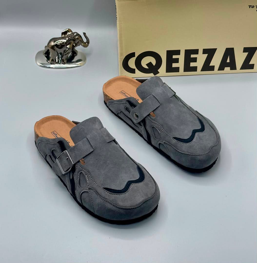 root A pair of gray suede double-buckle mule shoes for men, showcasing Modern Luxury and Urban Edge style, perfect for adding a touch of sophistication to any outfit in Nigeria.