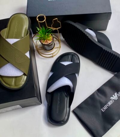 A pair of Emporio Armani olive green and black cross-strap slide sandals, presented with their respective boxes and packaging, embodying Modern Luxury and Urban Edge.
