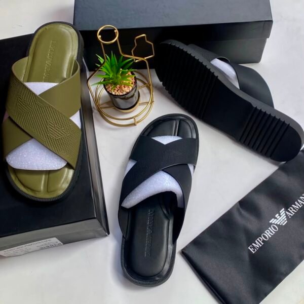 A pair of Emporio Armani olive green and black cross-strap slide sandals, presented with their respective boxes and packaging, embodying Modern Luxury and Urban Edge.