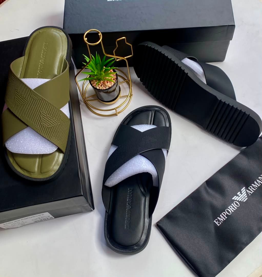 root A pair of Emporio Armani olive green and black cross-strap slide sandals, presented with their respective boxes and packaging, embodying Modern Luxury and Urban Edge.