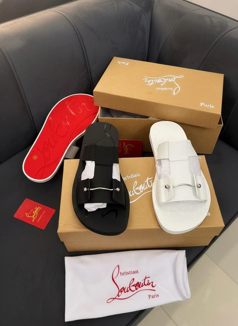 root Christian Louboutin Paris sandals in black and white, displayed with luxury packaging and accessories, embodying Modern Luxury and Urban Edge.