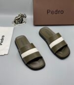 A pair of stylish brown slides with navy blue and white stripes, presented with a brown box and accessories.
