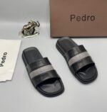 A pair of stylish brown slides with navy blue and white stripes, presented with a brown box and accessories.