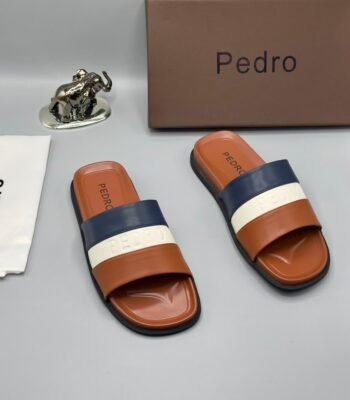 A pair of stylish brown slides with navy blue and white stripes, presented with a brown box and accessories.