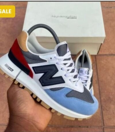 Experience Modern Luxury with these sleek New Balance sneakers, featuring a unique blend of white, blue, red, and black hues, perfectly embodying the Urban Edge spirit in Nigeria.