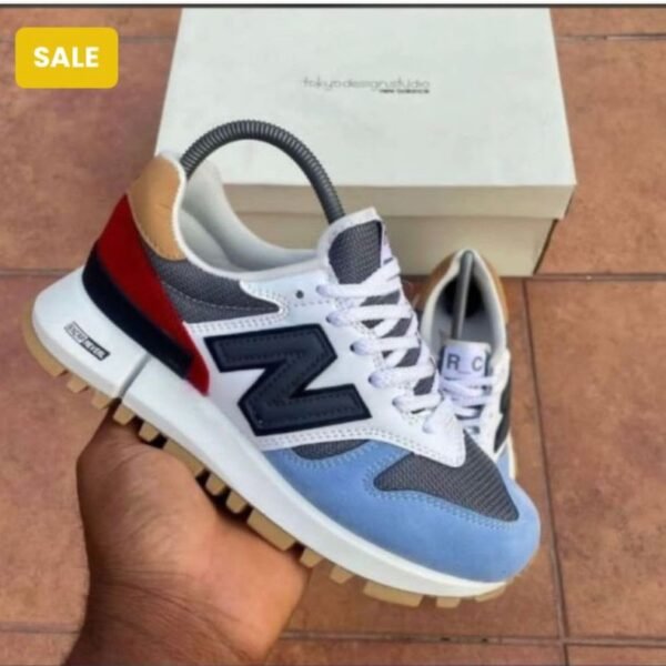 Experience Modern Luxury with these sleek New Balance sneakers, featuring a unique blend of white, blue, red, and black hues, perfectly embodying the Urban Edge spirit in Nigeria.