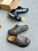 A pair of black clogs with white Bonanza Storm Rider branding and a pair of grey clogs with a cracked pattern, showcasing modern luxury footwear.