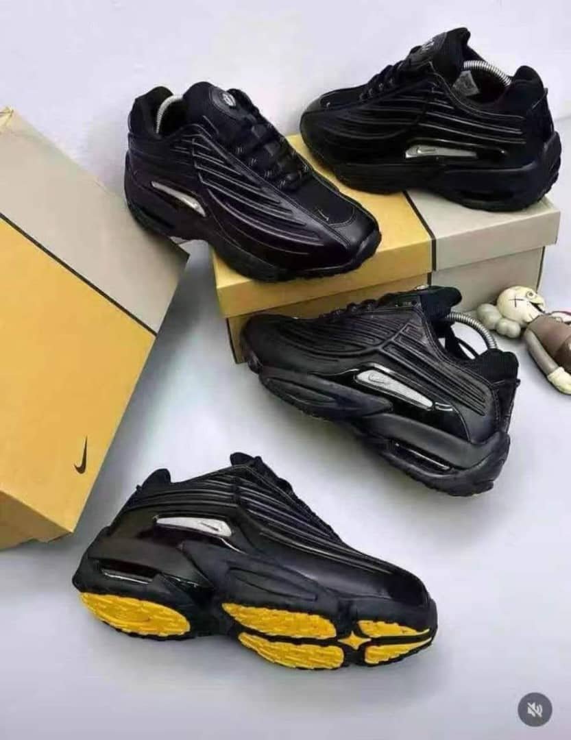 root A stylish pair of black sneakers with yellow soles, embodying Modern Luxury and Urban Edge, displayed on a pristine white background.