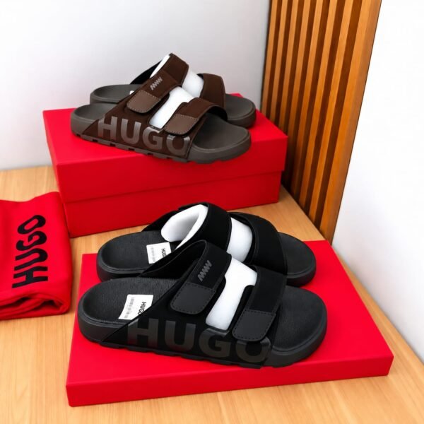 A pair of black and brown HUGO slides on red shoe boxes, showcasing Modern Luxury, Urban Edge, and Timeless Quality.