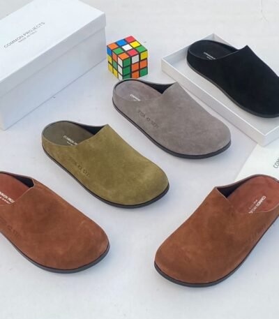 A stylish display of suede half shoes in various colors, exuding Modern Luxury and Urban Edge, with a focus on Timeless Quality.
