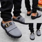 A stylish pair of grey half shoes with a gold buckle, showcased from multiple angles, exuding modern luxury and urban edge.